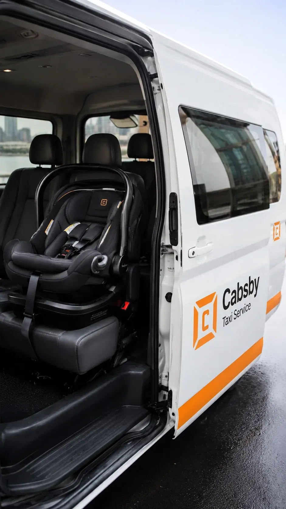 Child restraint fitted in the rear seat of a taxi